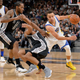 Stephen Curry drives around Kawhi Leonard and a staggering Patty Mills. Via AP.